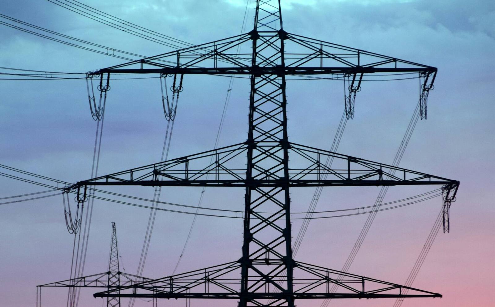 High-voltage transmission lines at dusk